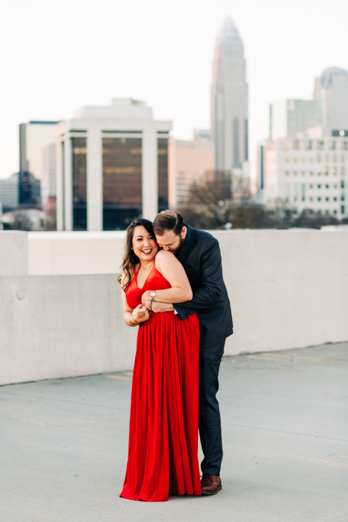 Uptown Charlotte engagement photo with skyline in the background from a parking deck