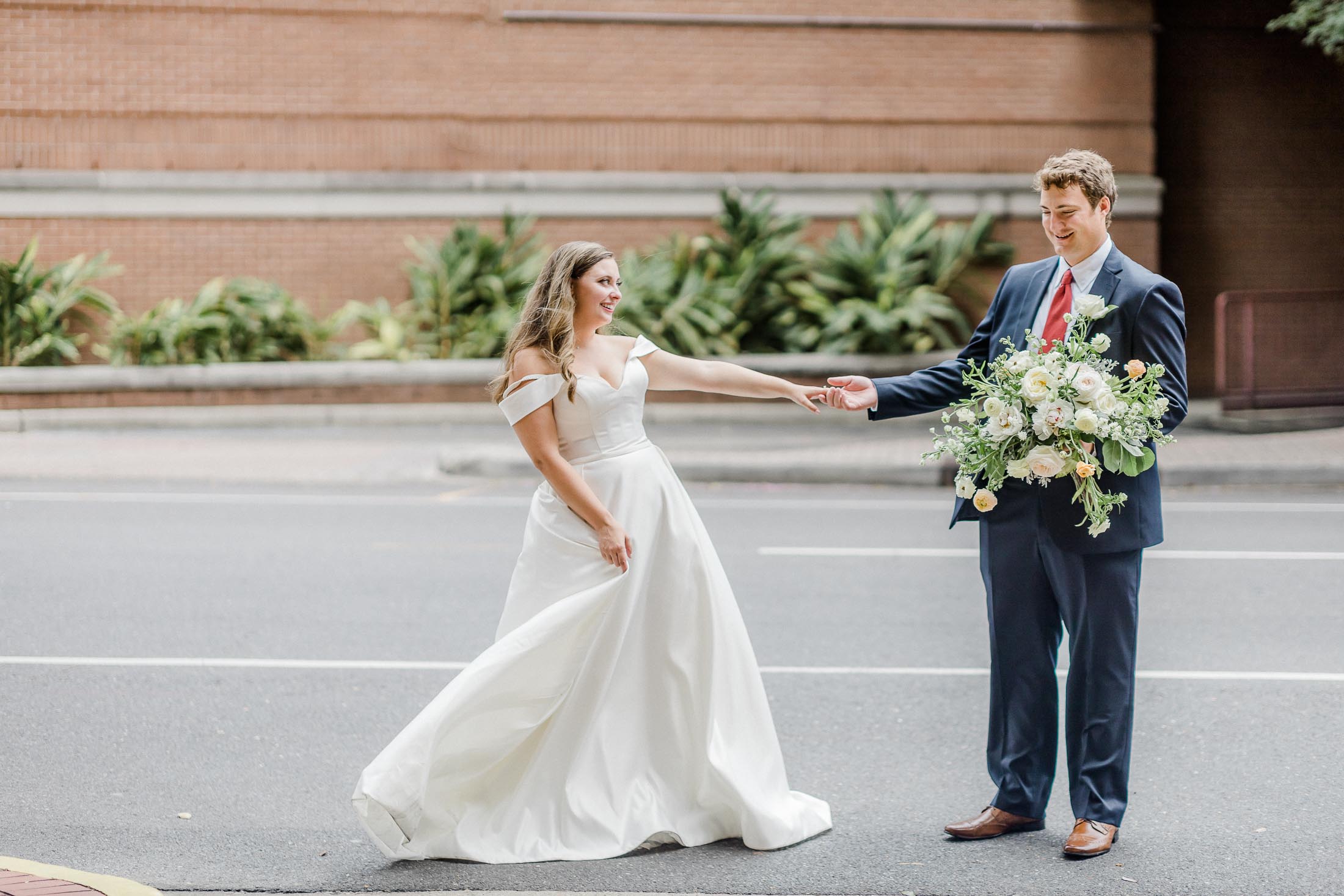 couple in new orleans street on wedding day