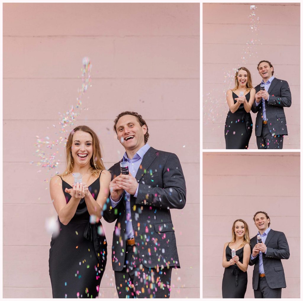 confetti popping from couple against pink wall
