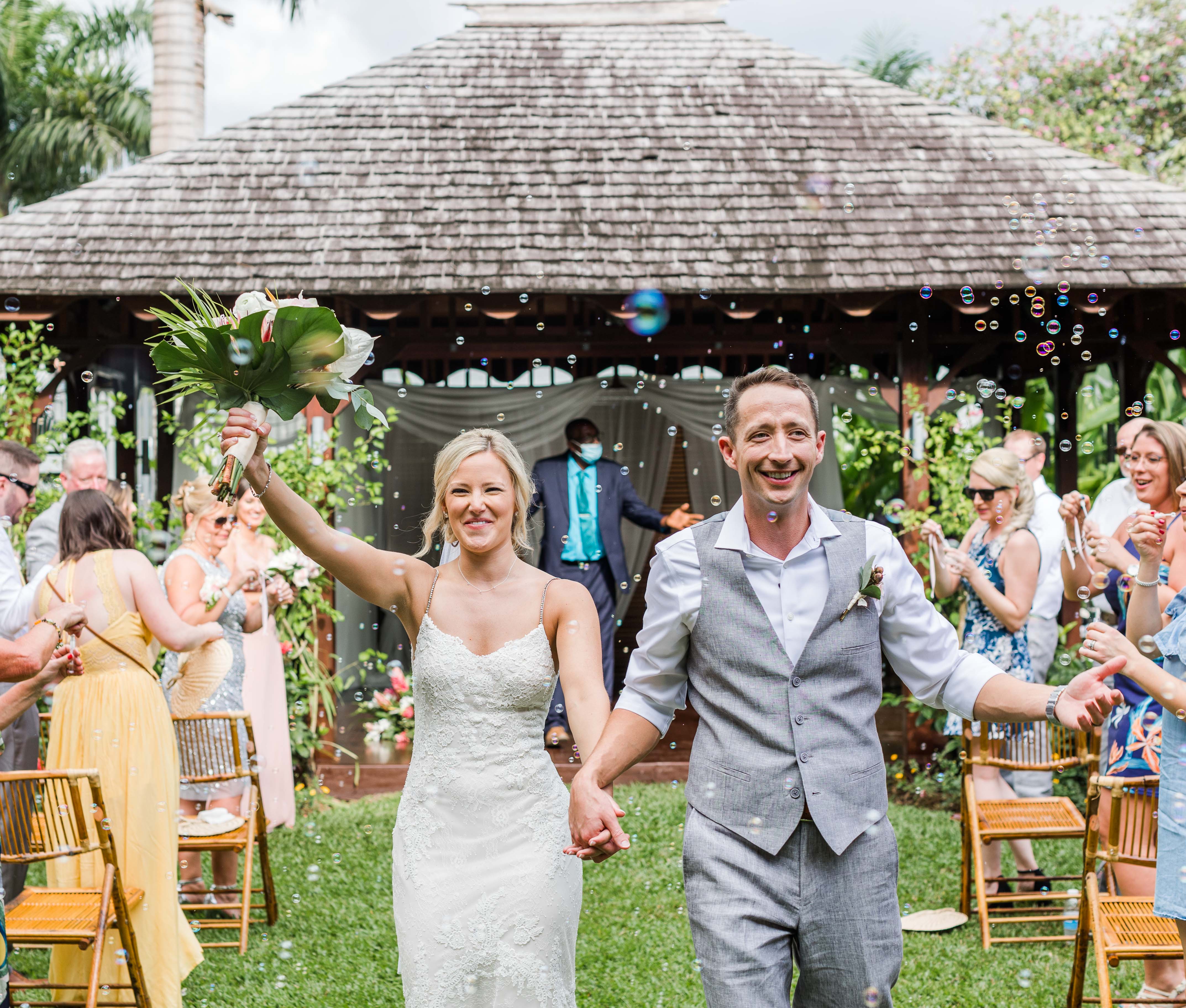 couple walks through aisle of bubbles after sandals negril wedding