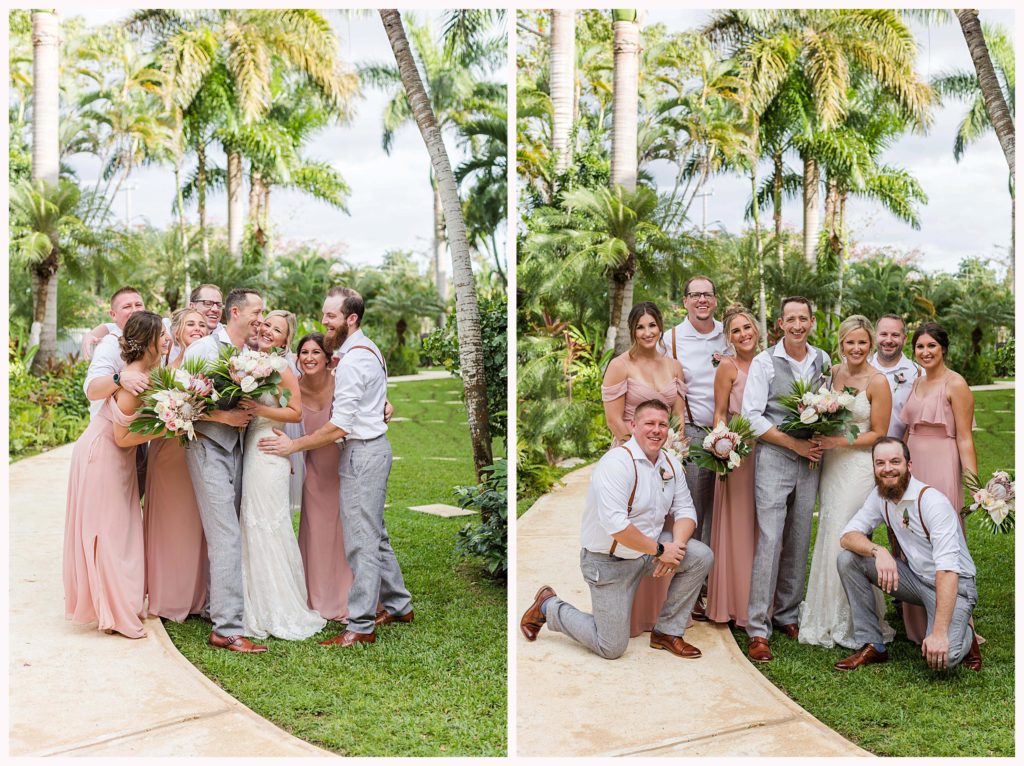 wedding party gives bridal couple a group hug surrounded by palm trees