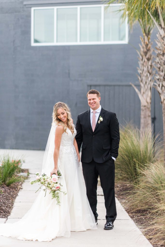 bride and groom smile and laugh on charleston wedding day