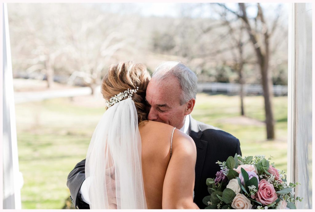 dad embraces his daughter on her wedding day