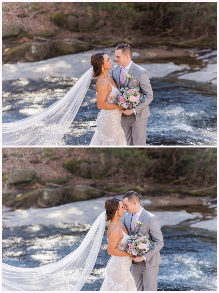 bride and groom near water with pink,  purple, and white flowers