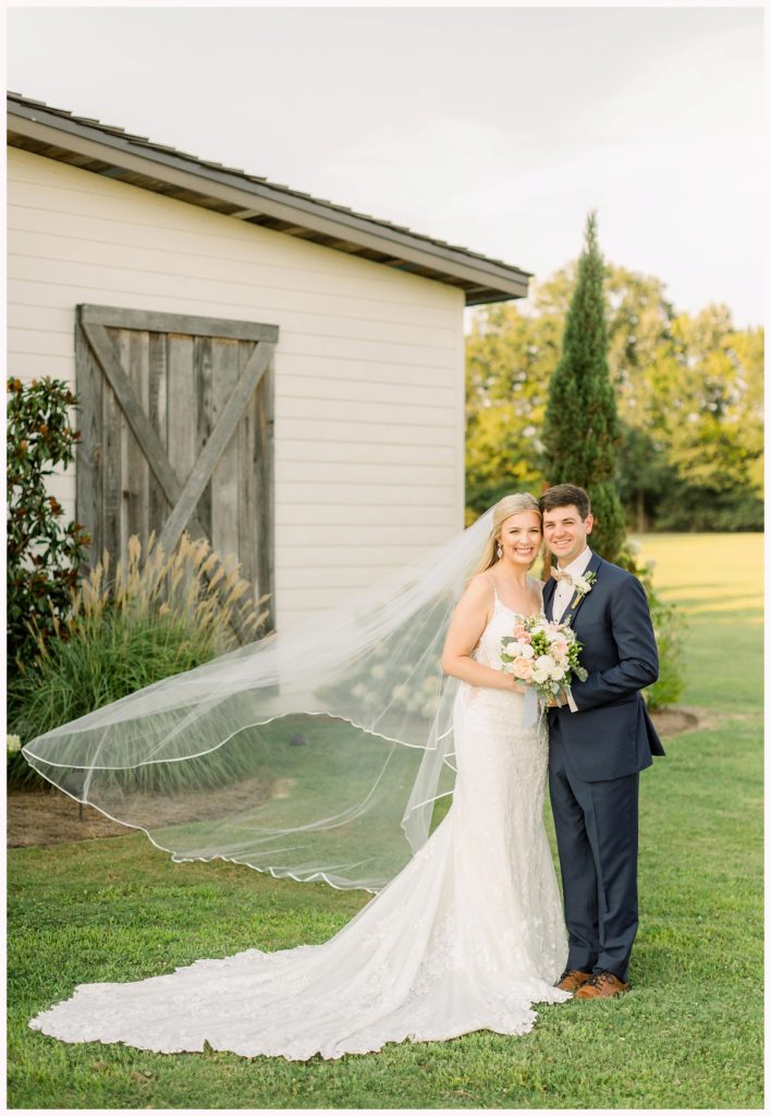 bride and groom smile at the camera in madison, mississippi