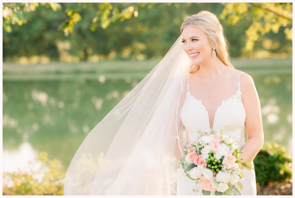 southern bride smiles off to the right with flowing veil