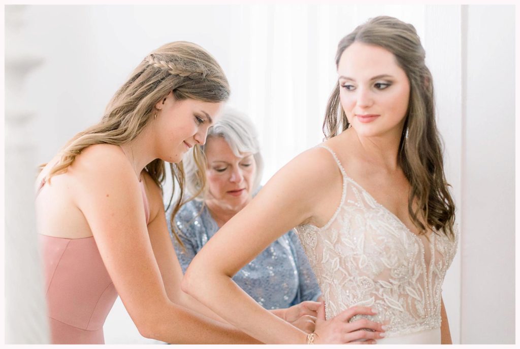 bride has mom and sister button wedding dress