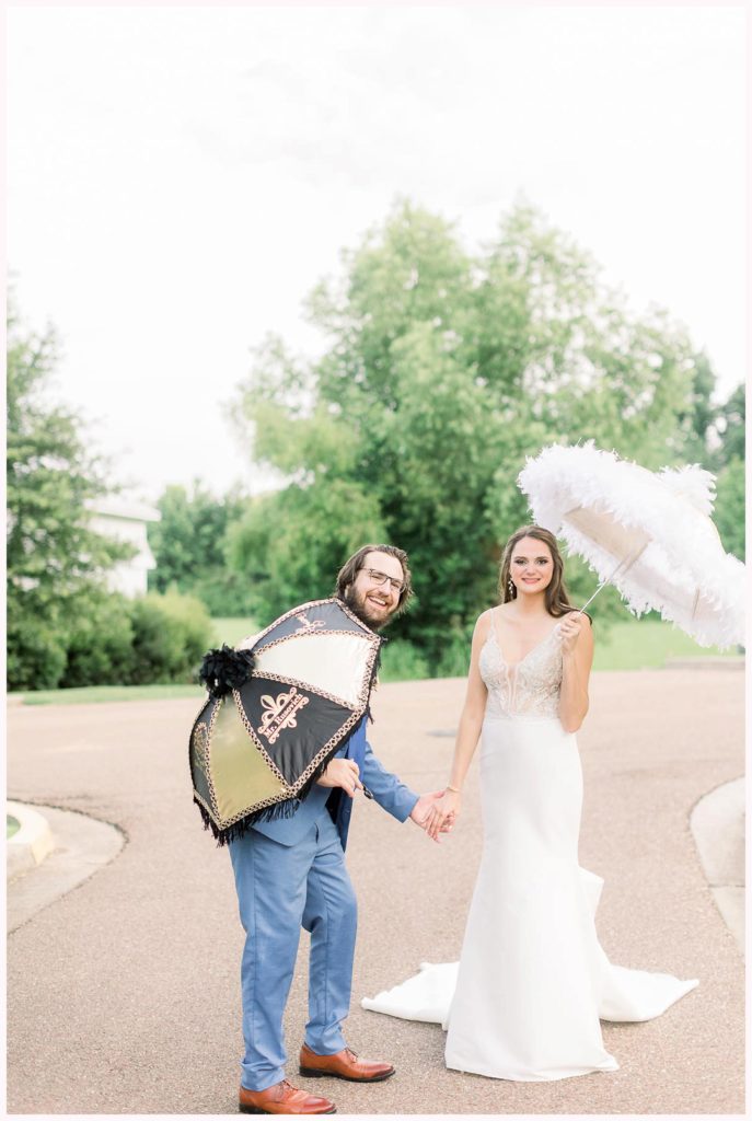 bride and groom celebrate new orleans style wedding with second line umbrellas 