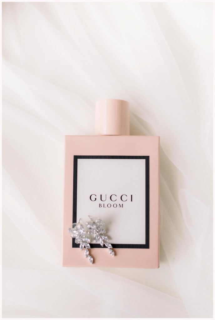 gucci bloom perfume with crystal earrings on top