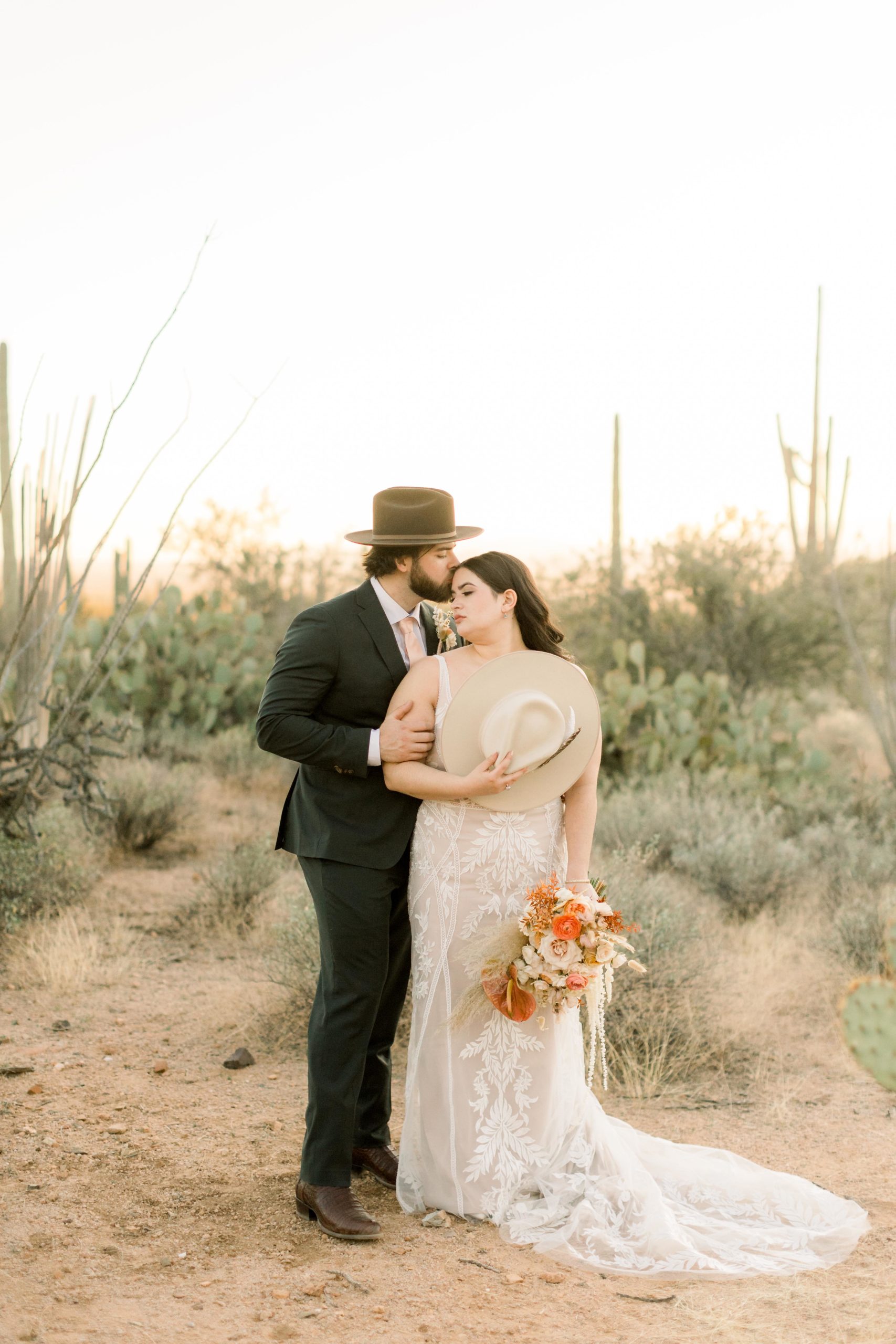 bride and groom pose in saguaro national park