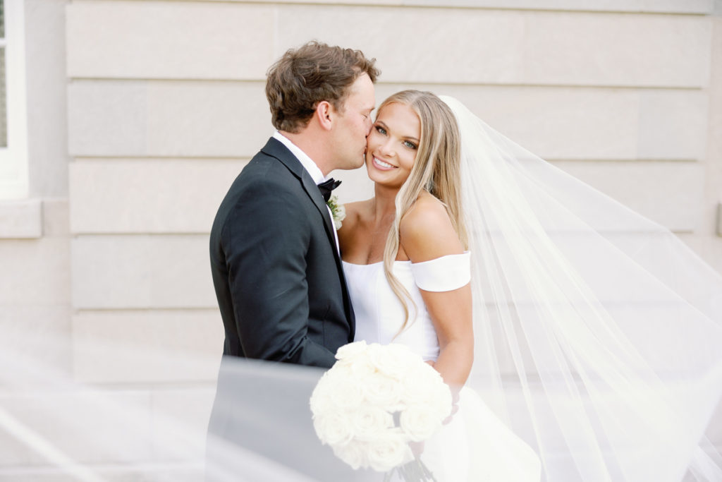 bride and groom in classic southern white dress and black tuxedo