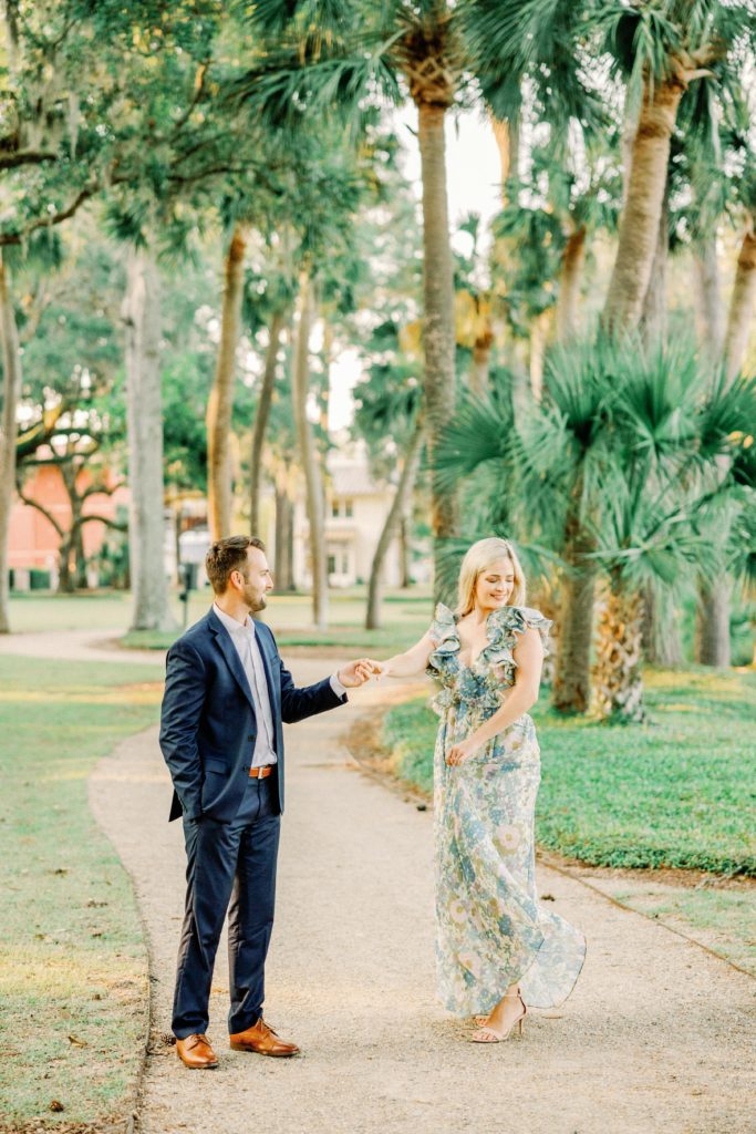 engagement photos of couple walking down path in palmetto bluff