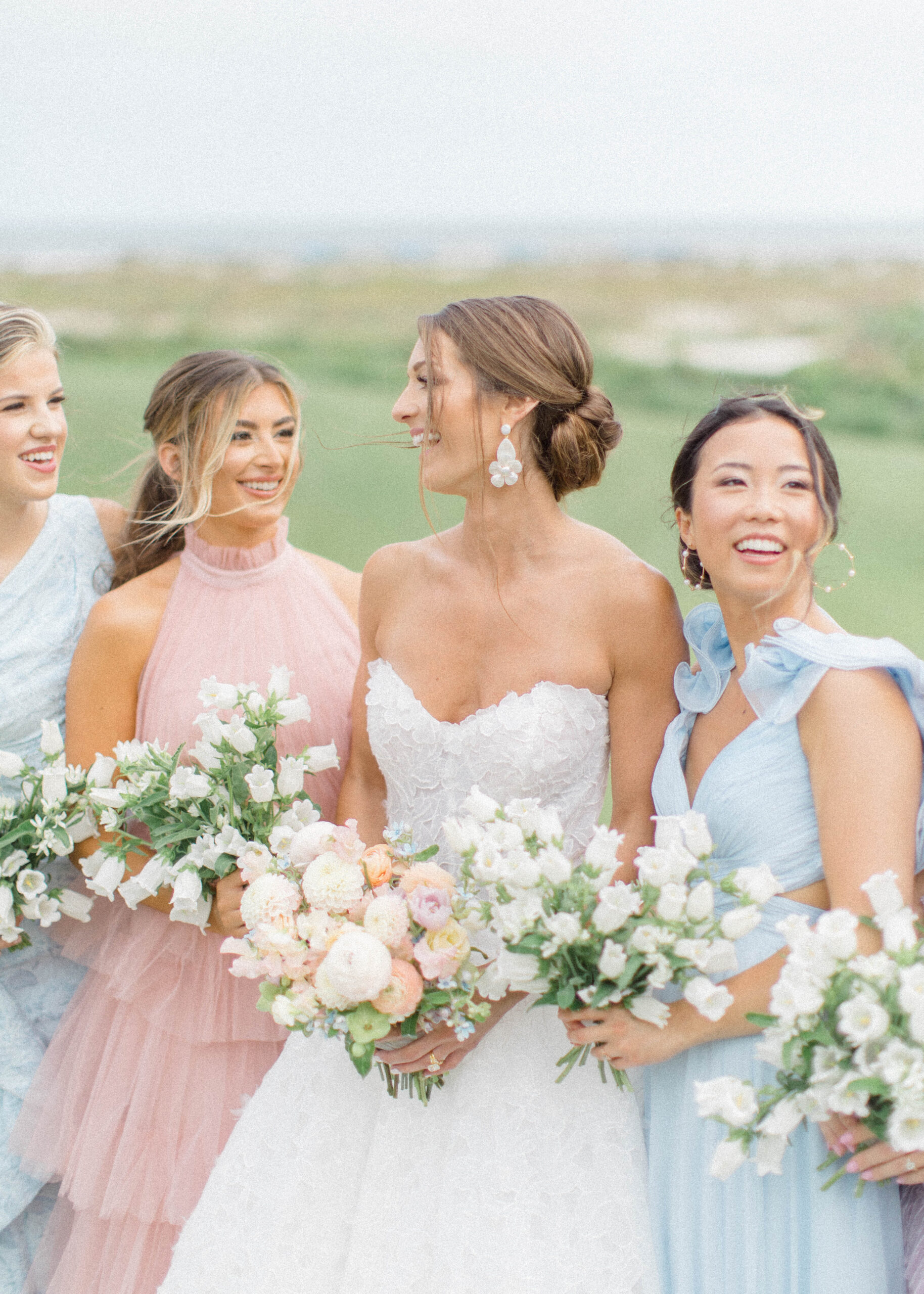 mix matched bridesmaids dresses on the ocean course